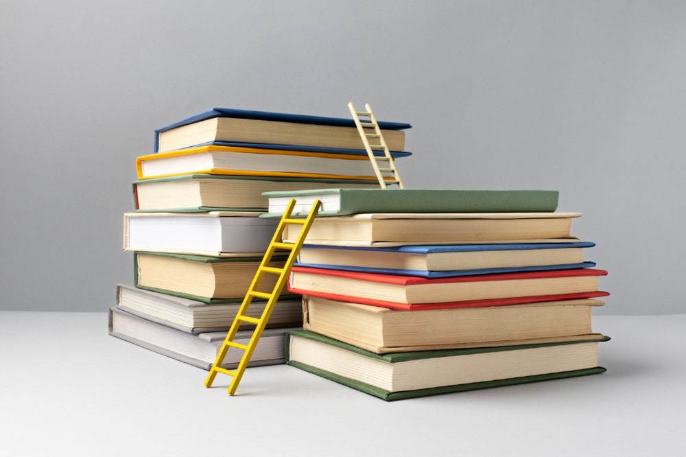 front-view-stacked-books-ladders-education-day-min