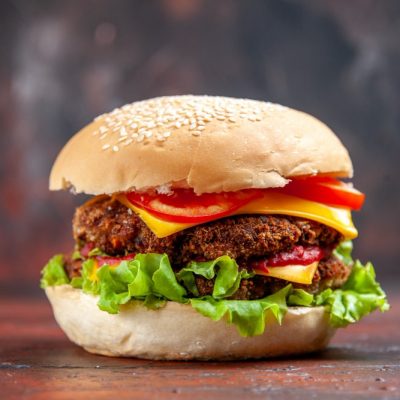 front-view-tasty-meat-burger-with-cheese-salad-dark-background-min