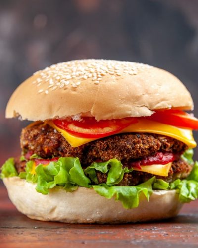 front-view-tasty-meat-burger-with-cheese-salad-dark-background-min