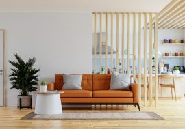 living-room-interior-wall-mockup-warm-tones-with-leather-sofa-which-is-kitchen-3d-rendering-min