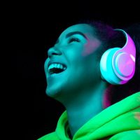 headphones-african-american-woman-s-portrait-isolated-dark-studio-background-multicolored-neon-light-beautiful-female-model-concept-human-emotions-facial-expression-sales-ad-fashion-min