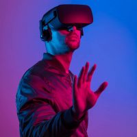 man-wearing-vr-glasses-with-gradient-background_23-2148864957