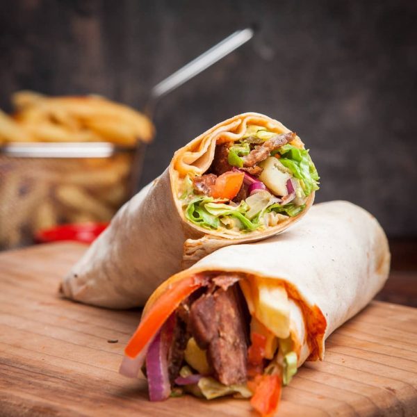 side-view-shawarma-with-fried-potatoes-board-cookware_176474-3215